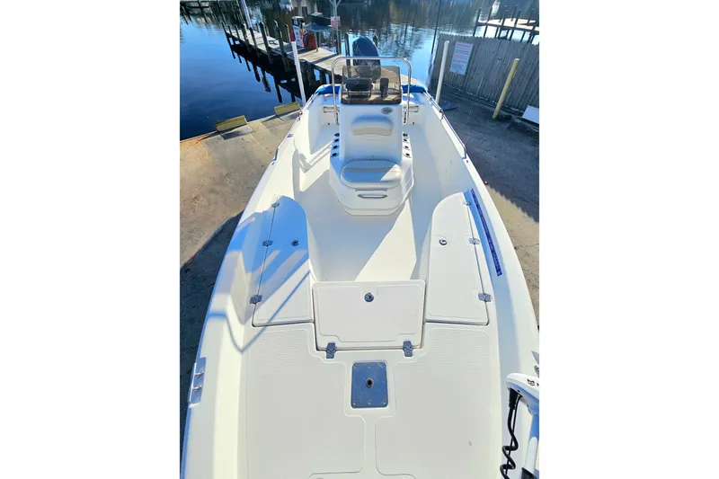 Slide: The Image of 2007 NauticStar 2110 Nautic Bay boat, white deck, docked by calm water. - 5