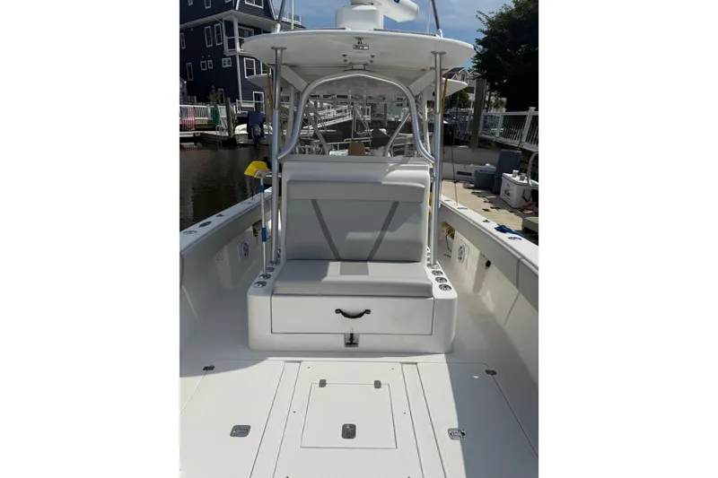 Slide: The Image of 2006 SeaVee 340B boat interior with seating and storage, docked at marina. - 14