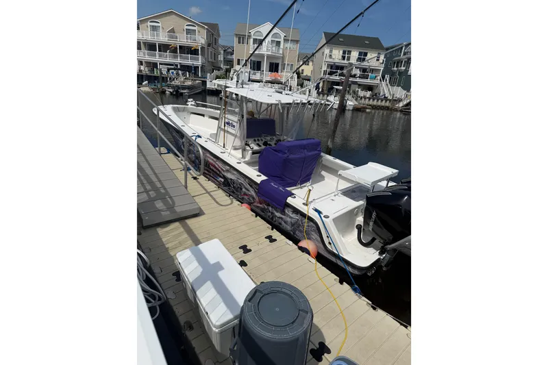 Slide: The Image of 2006 SeaVee 340B boat docked near waterfront homes on a sunny day. - 17