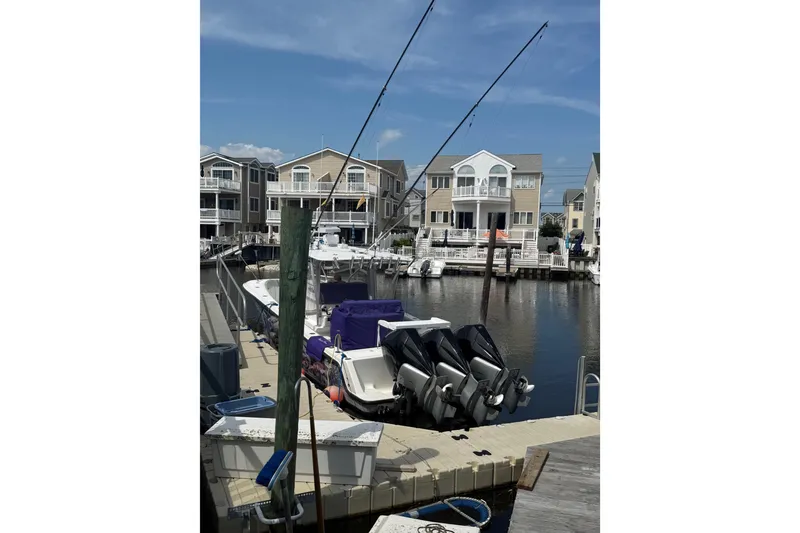 Slide: The Image of 2006 SeaVee 340B boat docked in a marina with waterfront homes in the background. - 18