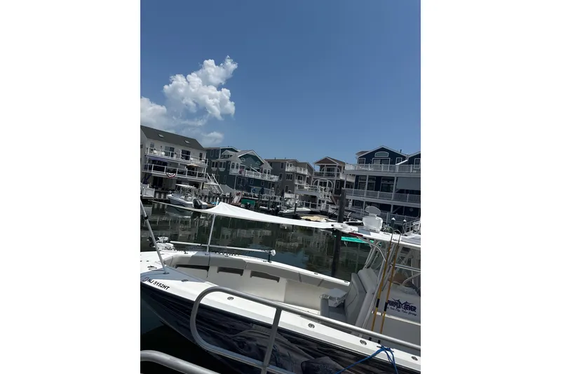 Slide: The Image of 2006 SeaVee 340B boat docked in a marina with waterfront homes. - 19