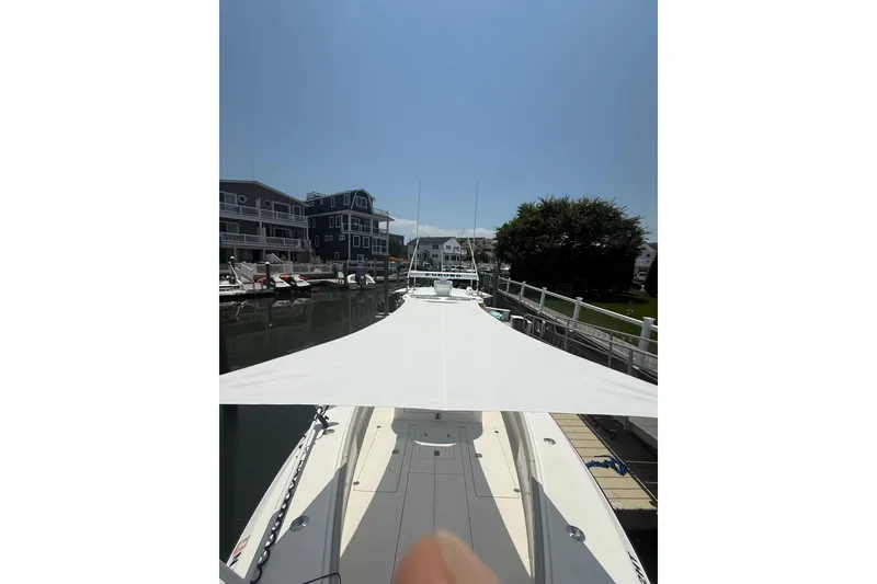 Slide: The Image of 2006 SeaVee 340B boat docked in a marina, surrounded by waterfront buildings. - 20