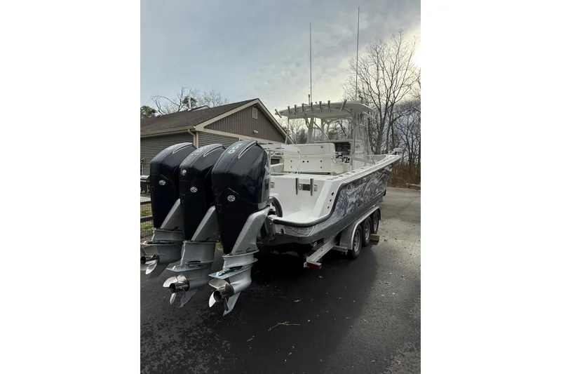 Slide: The Image of 2006 SeaVee 340B boat with triple outboard engines on a trailer. - 25