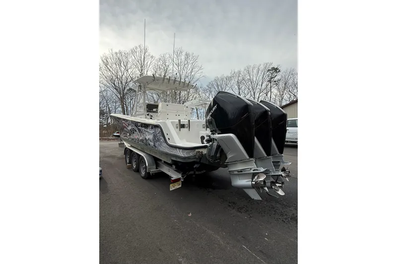 Slide: The Image of 2006 SeaVee 340B boat with triple outboard engines on a trailer. - 26