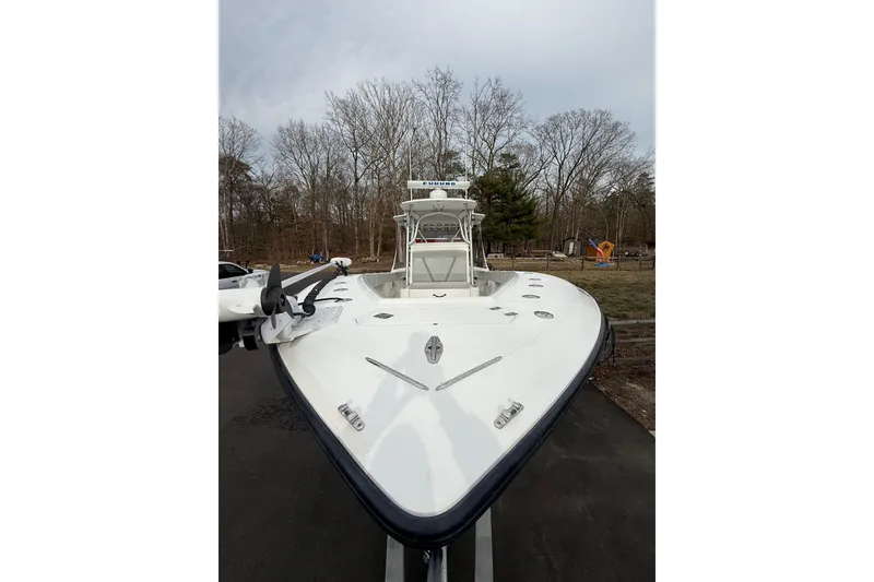 Slide: The Image of 2006 SeaVee 340B boat on trailer, parked outdoors with trees in background. - 27