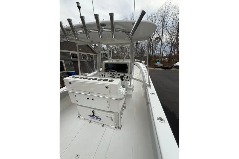 Slide: The Image of 2006 SeaVee 340B boat interior with rod holders and console, docked outdoors. - 29