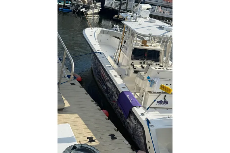 Slide: The Image of 2006 SeaVee 340B boat docked at marina, featuring fishing equipment and clean deck. - 3
