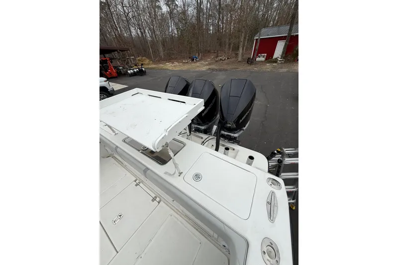 Slide: The Image of 2006 SeaVee 340B boat with triple Mercury outboard engines in a wooded driveway. - 33