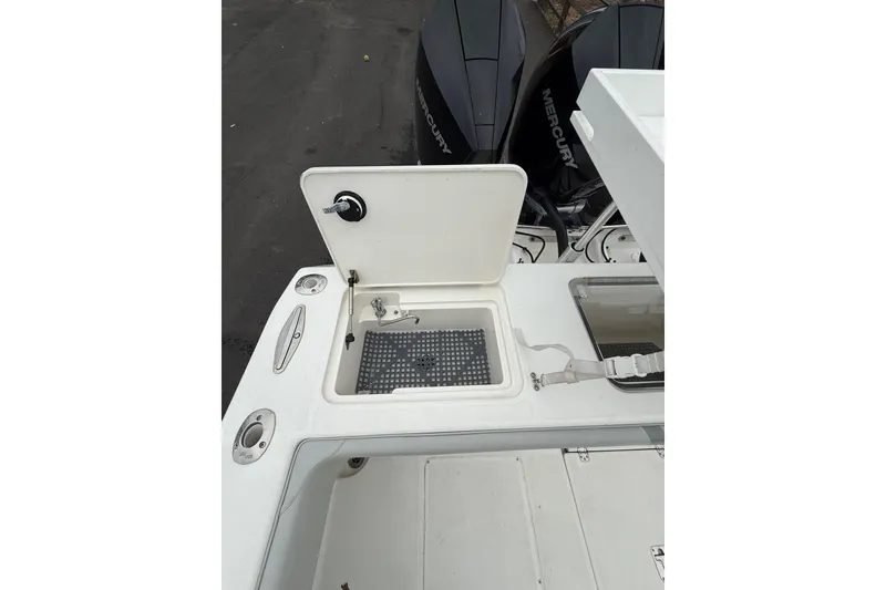 Slide: The Image of 2006 SeaVee 340B boat deck with open storage compartment and Mercury engines. - 35