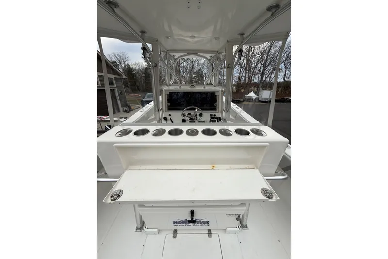 Slide: The Image of 2006 SeaVee 340B boat interior with helm, rod holders, and storage compartments. - 41