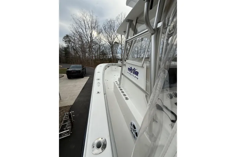 Slide: The Image of 2006 SeaVee 340B boat docked, showcasing sleek design and spacious deck. - 46