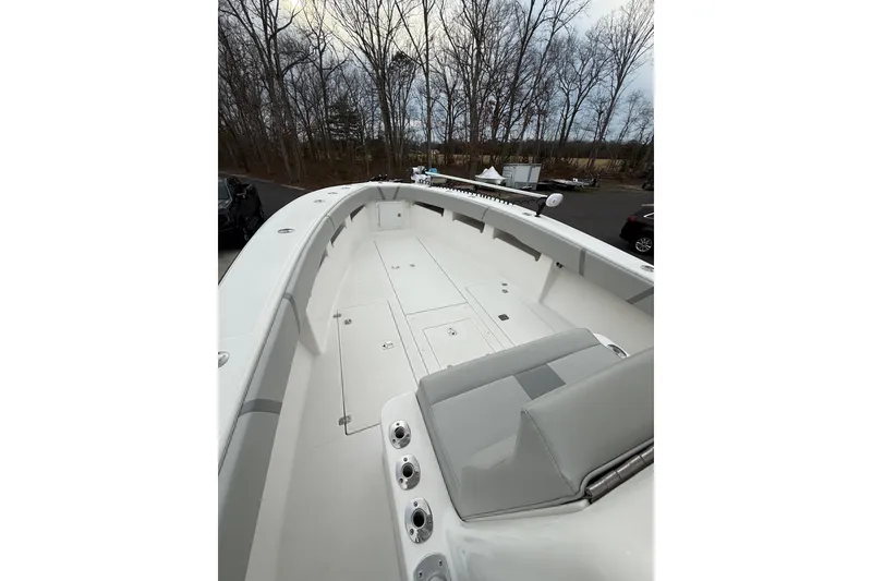 Slide: The Image of 2006 SeaVee 340B boat deck with seating, rod holders, and storage compartments. - 53