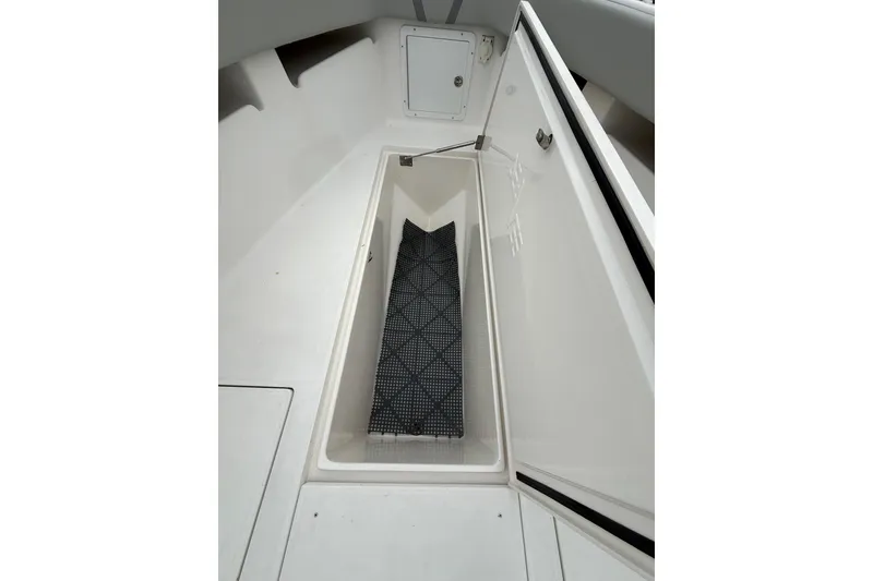 Slide: The Image of Open storage compartment on 2006 SeaVee 340B boat, featuring a non-slip mat inside. - 59