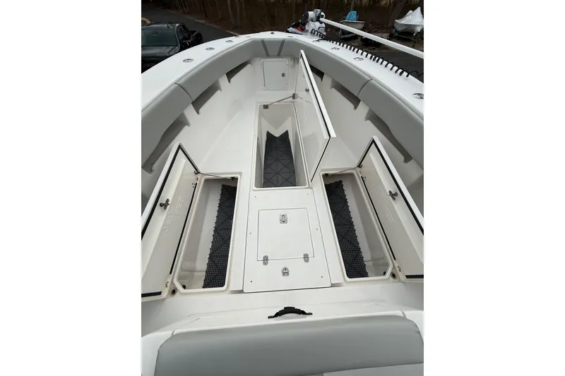 Slide: The Image of 2006 SeaVee 340B boat deck with open storage compartments and cushioned seating. - 60
