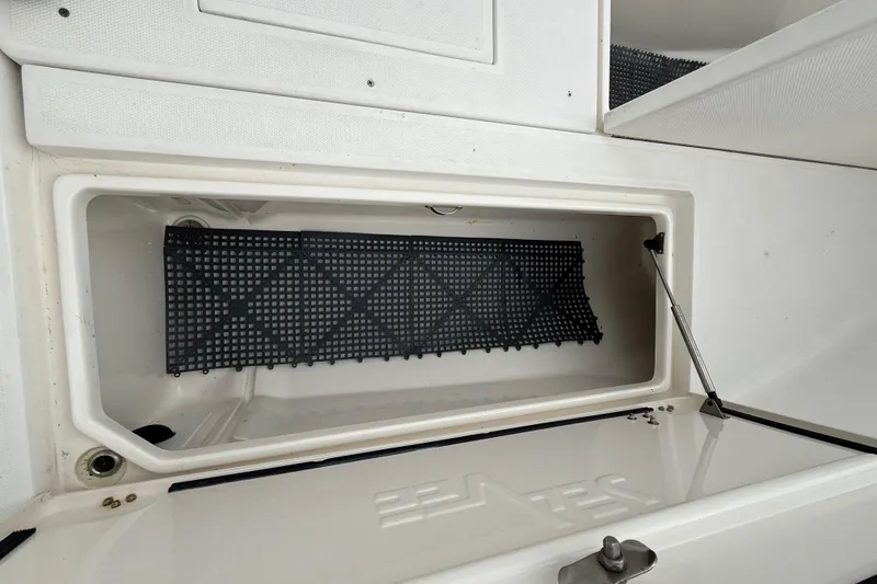 Slide: The Image of Storage compartment of a 2006 SeaVee 340B boat with a black mat inside. - 62
