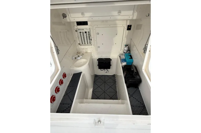 Slide: The Image of 2006 SeaVee 340B boat interior with control panel, storage, and sink. - 65