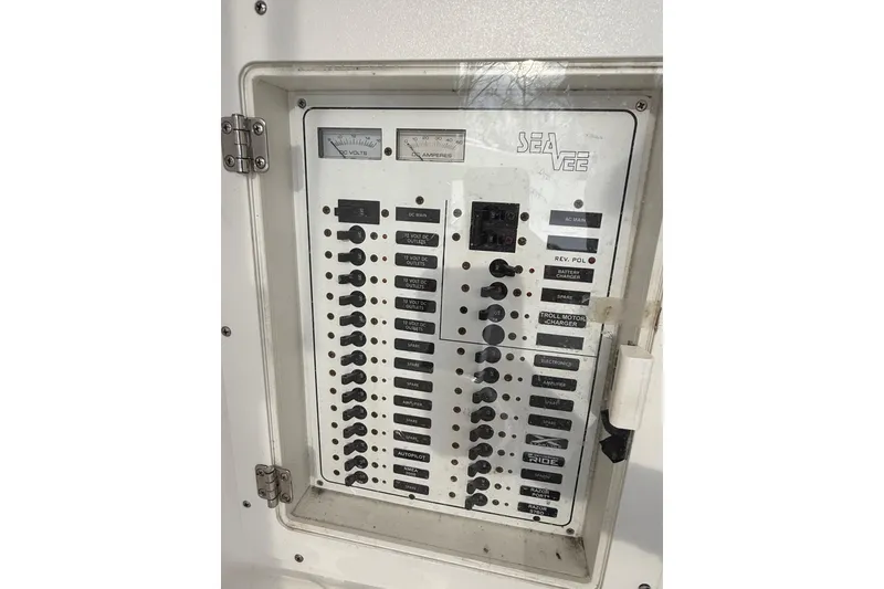 Slide: The Image of Electrical panel of a 2006 SeaVee 340B boat with various switches and gauges. - 67
