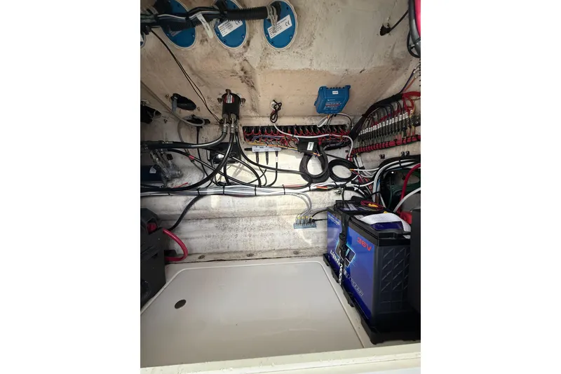 Slide: The Image of Electrical system inside a 2006 SeaVee 340B boat, featuring wiring and batteries. - 68