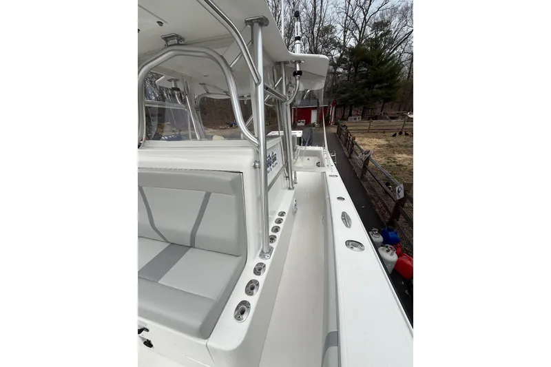 Slide: The Image of 2006 SeaVee 340B boat interior with seating and rod holders, docked outdoors. - 74
