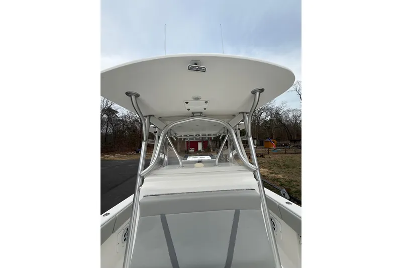 Slide: The Image of 2006 SeaVee 340B boat with T-top and console, parked outdoors. - 77