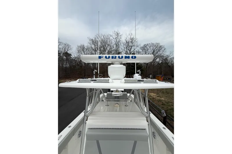 Slide: The Image of 2006 SeaVee 340B boat with Furuno radar, docked near trees under cloudy sky. - 78
