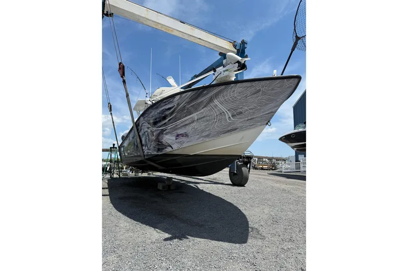 Slide: The Image of 2006 SeaVee 340B boat on a lift, showcasing its sleek hull design. - 8