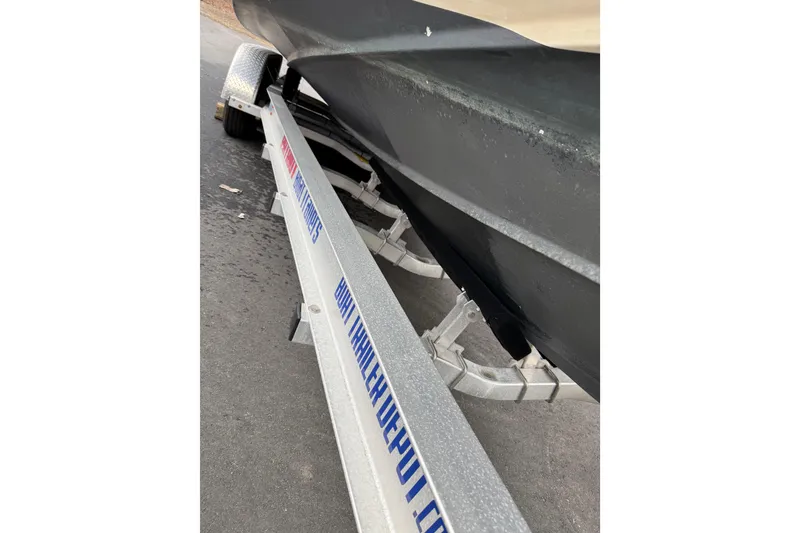 Slide: The Image of Trailer carrying a 2006 SeaVee 340B boat on a paved road. - 81