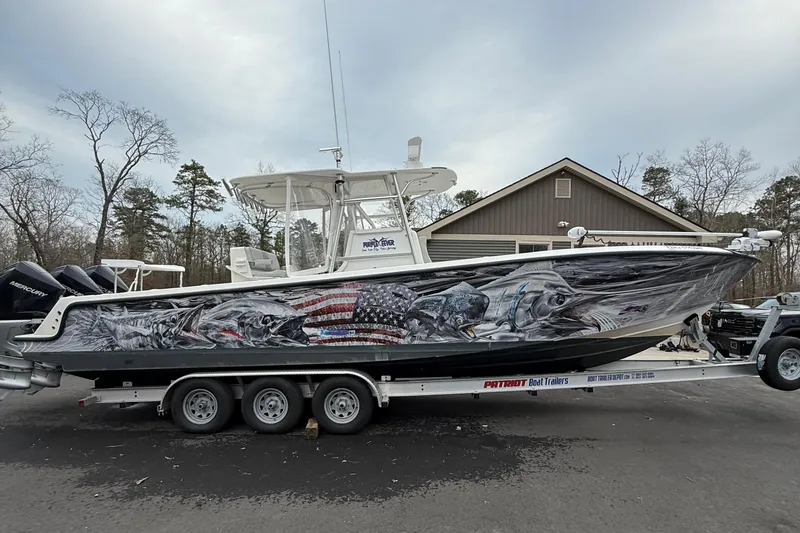 Slide: The Image of 2006 SeaVee 340B boat with vibrant fish and American flag graphics on a trailer. - 83