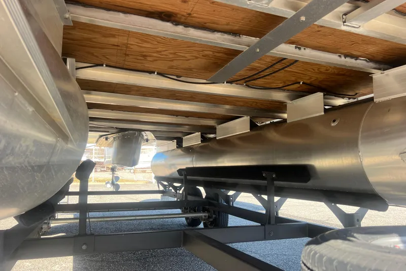 Slide: The Image of Underneath view of 2023 Sun Tracker Party Barge 20 DLX pontoon boat on trailer. - 14