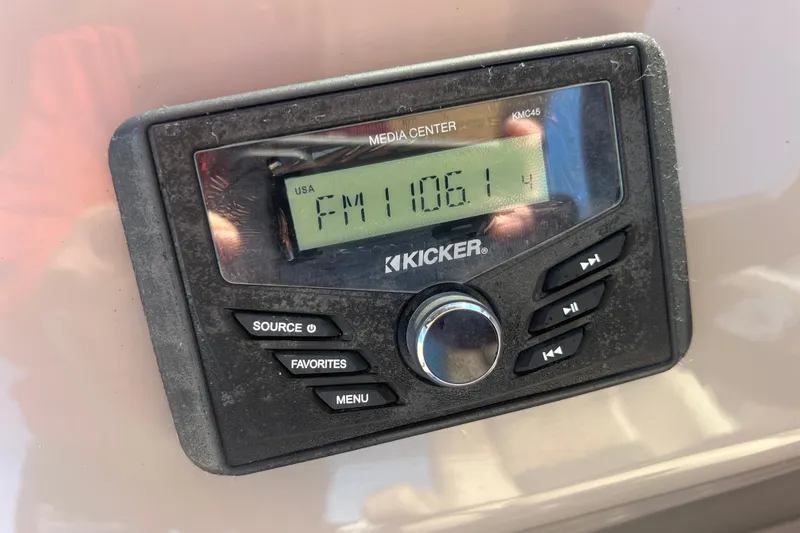 Slide: The Image of Kicker media center displaying FM 106.1 on a 2023 Sun Tracker Party Barge 20 DLX. - 16