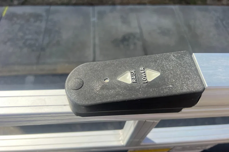 Slide: The Image of Control panel on 2023 Sun Tracker Party Barge 20 DLX, featuring raise and lower buttons. - 18