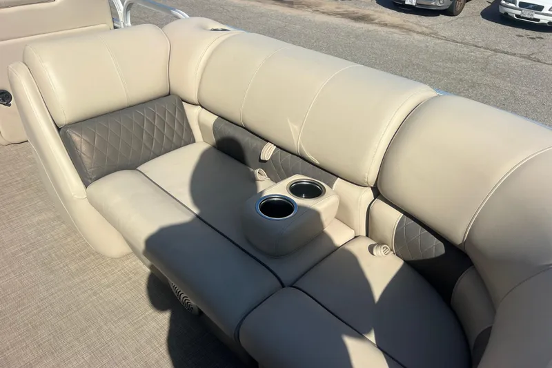 Slide: The Image of 2023 Sun Tracker Party Barge 20 DLX interior seating with cup holders, beige upholstery. - 21