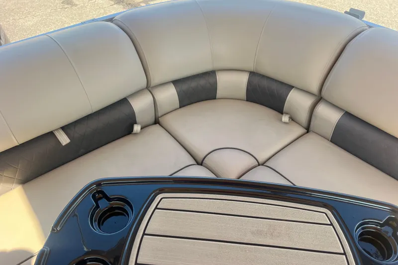Slide: The Image of 2023 Sun Tracker Party Barge 20 DLX interior with cushioned seating and table. - 28