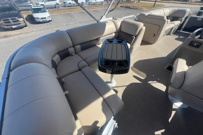 Slide: The Image of 2023 Sun Tracker Party Barge 20 DLX interior with plush seating and central table. - 29