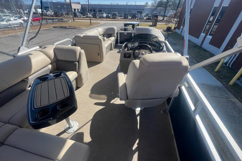 Slide: The Image of 2023 Sun Tracker Party Barge 20 DLX interior with seating and steering console. - 30