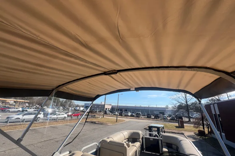 Slide: The Image of 2023 Sun Tracker Party Barge 20 DLX with canopy, parked outdoors. - 31