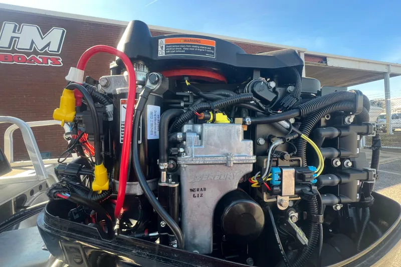 Slide: The Image of 2023 Sun Tracker Party Barge 20 DLX engine close-up, showcasing intricate wiring and components. - 33