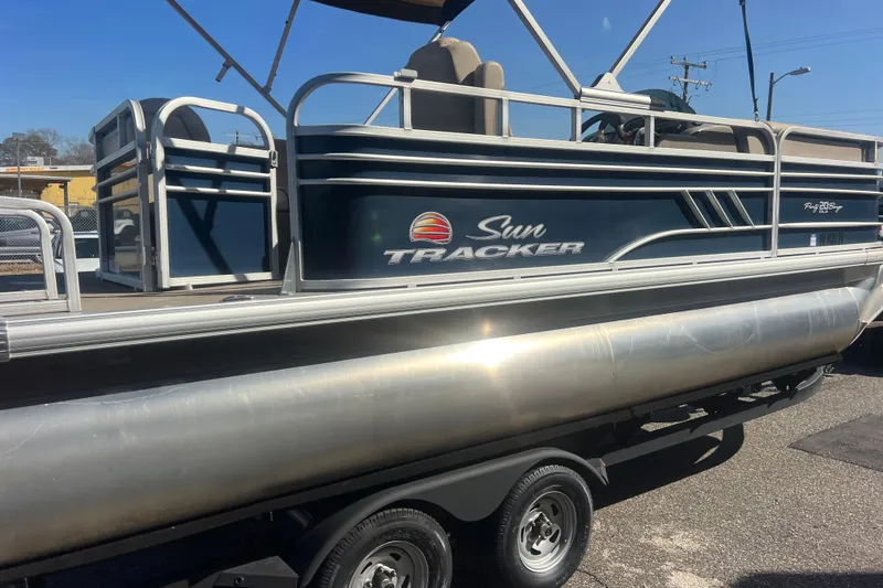 Slide: The Image of 2023 Sun Tracker Party Barge 20 DLX pontoon boat on trailer, side view. - 8