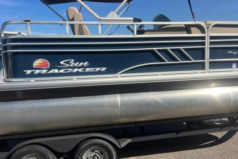 Slide: The Image of 2023 Sun Tracker Party Barge 20 DLX pontoon boat on trailer, side view. - 9