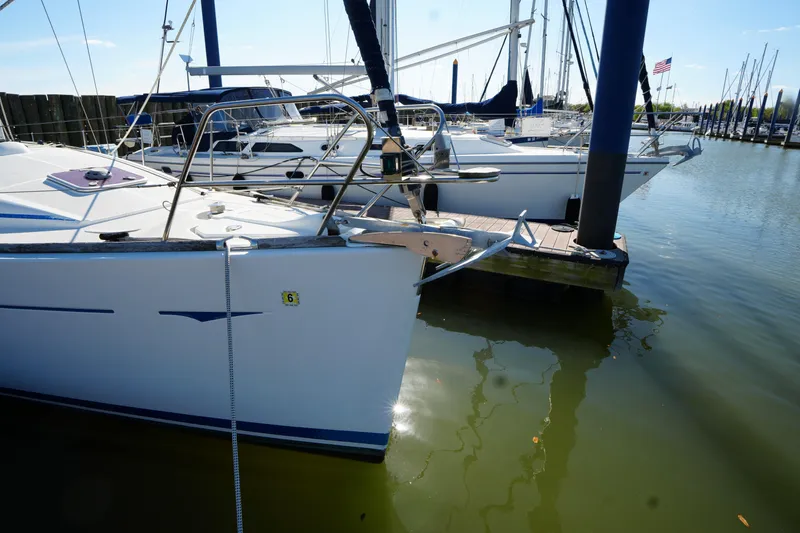 Slide: The Image of 2009 Jeanneau Sun Odyssey 36i sailboat docked at a marina, calm water reflection. - 11