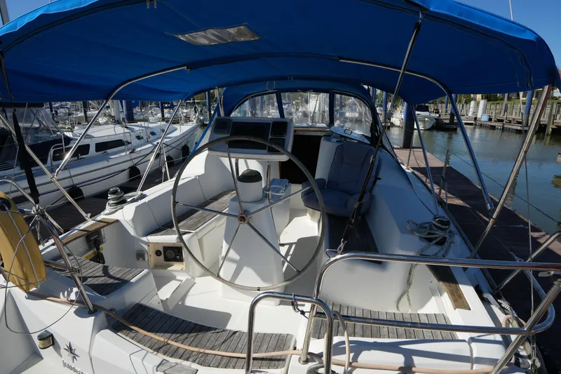 Slide: The Image of 2009 Jeanneau Sun Odyssey 36i sailboat cockpit with blue canopy at marina. - 13
