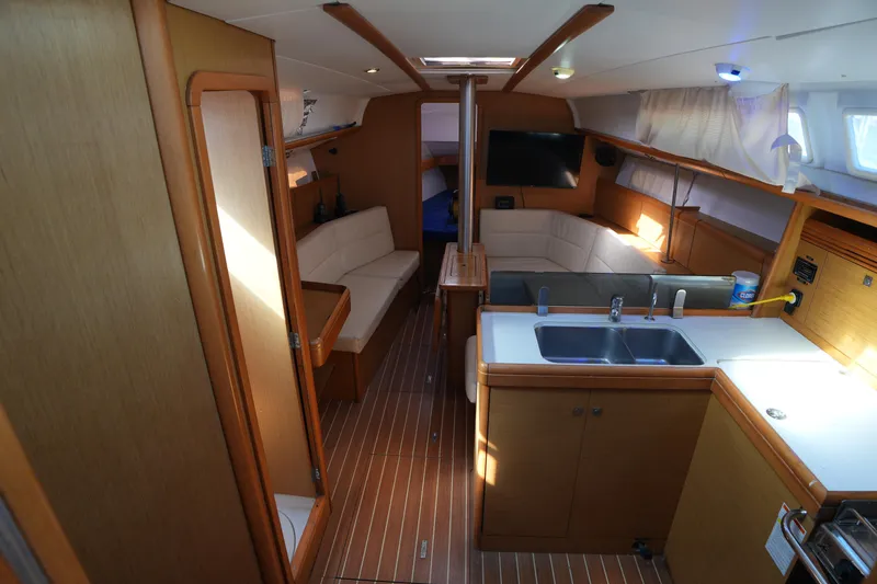 Slide: The Image of Interior of 2009 Jeanneau Sun Odyssey 36i yacht with modern kitchen and seating area. - 17