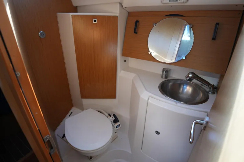 Slide: The Image of 2009 Jeanneau Sun Odyssey 36i yacht bathroom with sink, mirror, and toilet. - 26