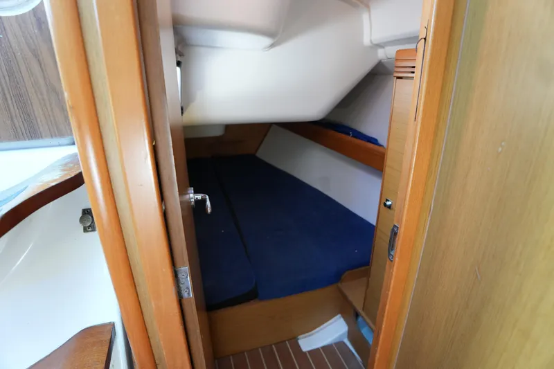 Slide: The Image of Cozy cabin interior of 2009 Jeanneau Sun Odyssey 36i sailboat with blue bedding. - 27