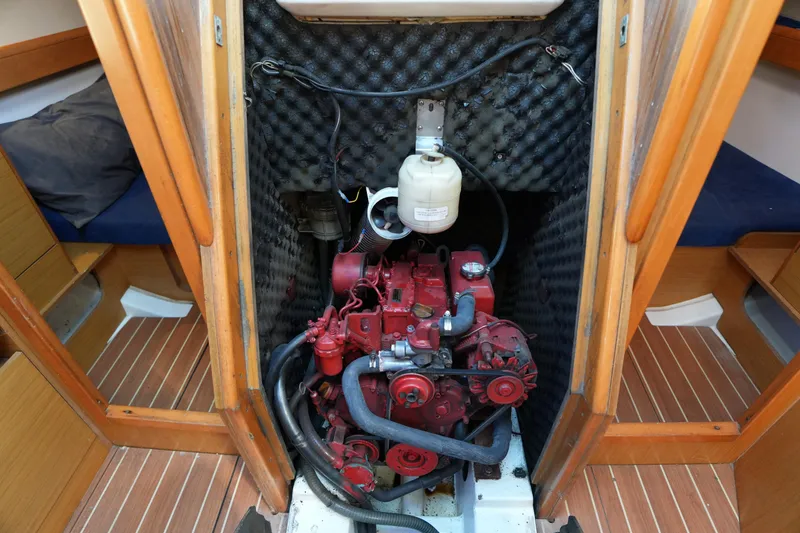 Slide: The Image of Engine compartment of 2009 Jeanneau Sun Odyssey 36i sailboat, featuring a red engine. - 29