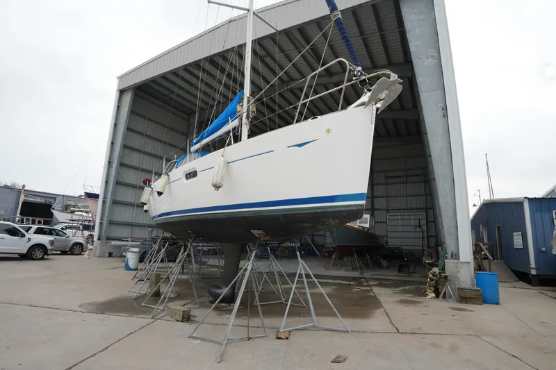 Slide: The Image of 2009 Jeanneau Sun Odyssey 36i sailboat in dry dock, supported by stands. - 4