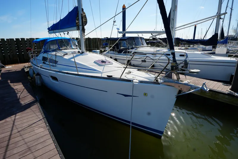 Slide: The Image of 2009 Jeanneau Sun Odyssey 36i sailboat docked at marina under clear sky. - 8