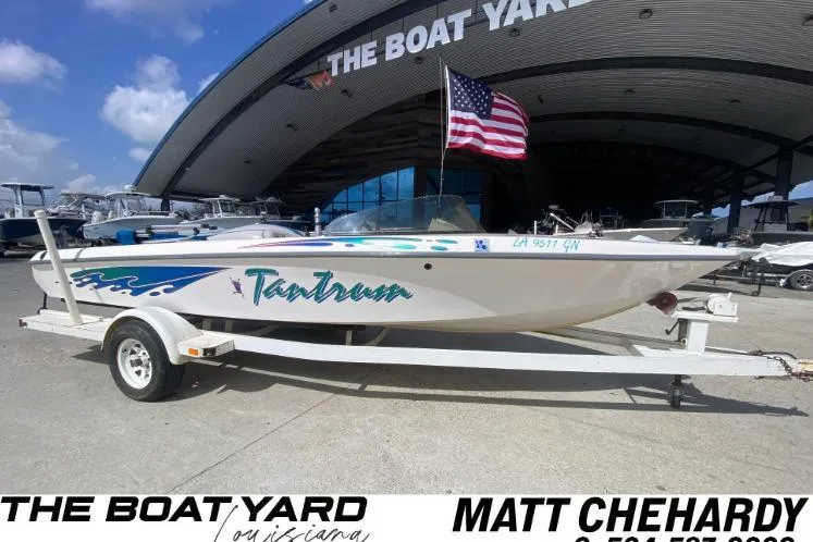 Slide: The Image of 1997 Malibu Tantrum boat on trailer at The Boat Yard, Louisiana, with American flag. - 1