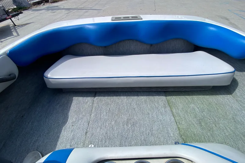 Slide: The Image of Interior of a 1997 Malibu Tantrum boat with blue and white seating. - 13