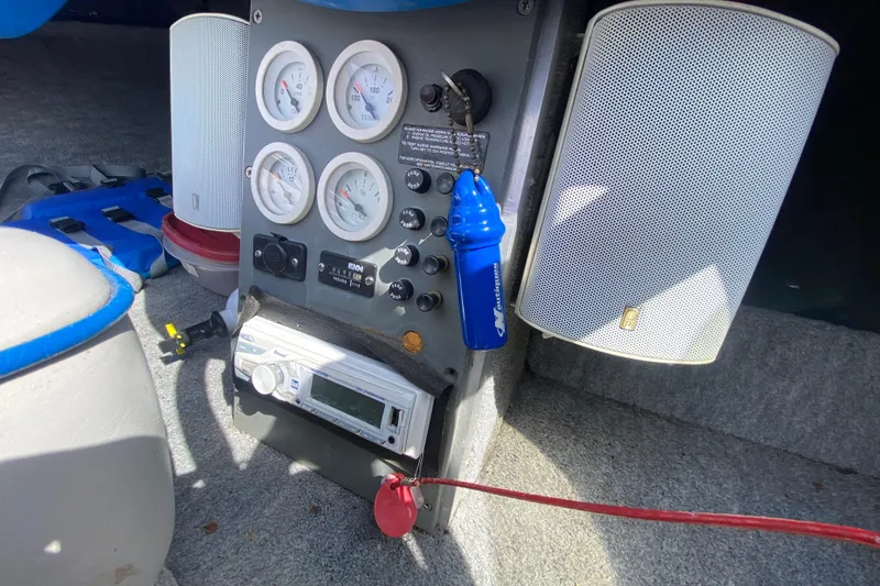 Slide: The Image of 1997 Malibu Tantrum boat dashboard with gauges, stereo, and speakers. - 14